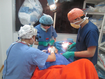 Andrew participating in the surgery of a girl with microtia.